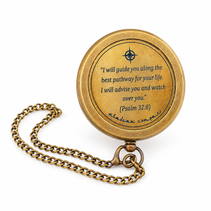 Original Path of God brass compass and chain on a plain white background